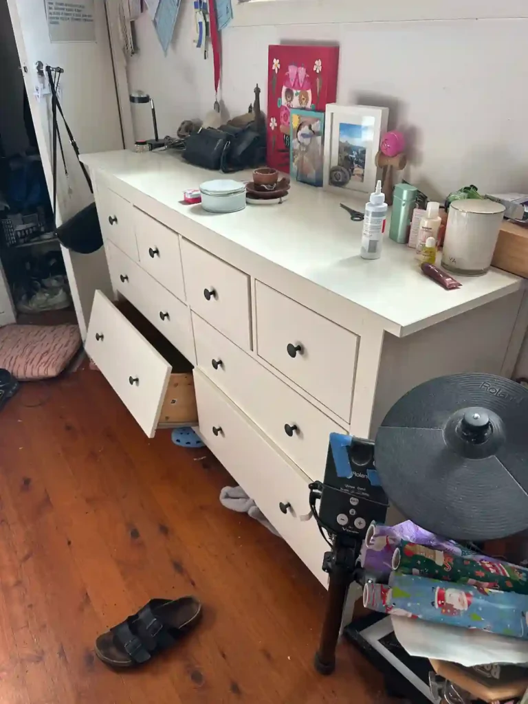 Sorting a cluttered room with a dresser by RubbishGo for Deceased Estate rubbish collection.