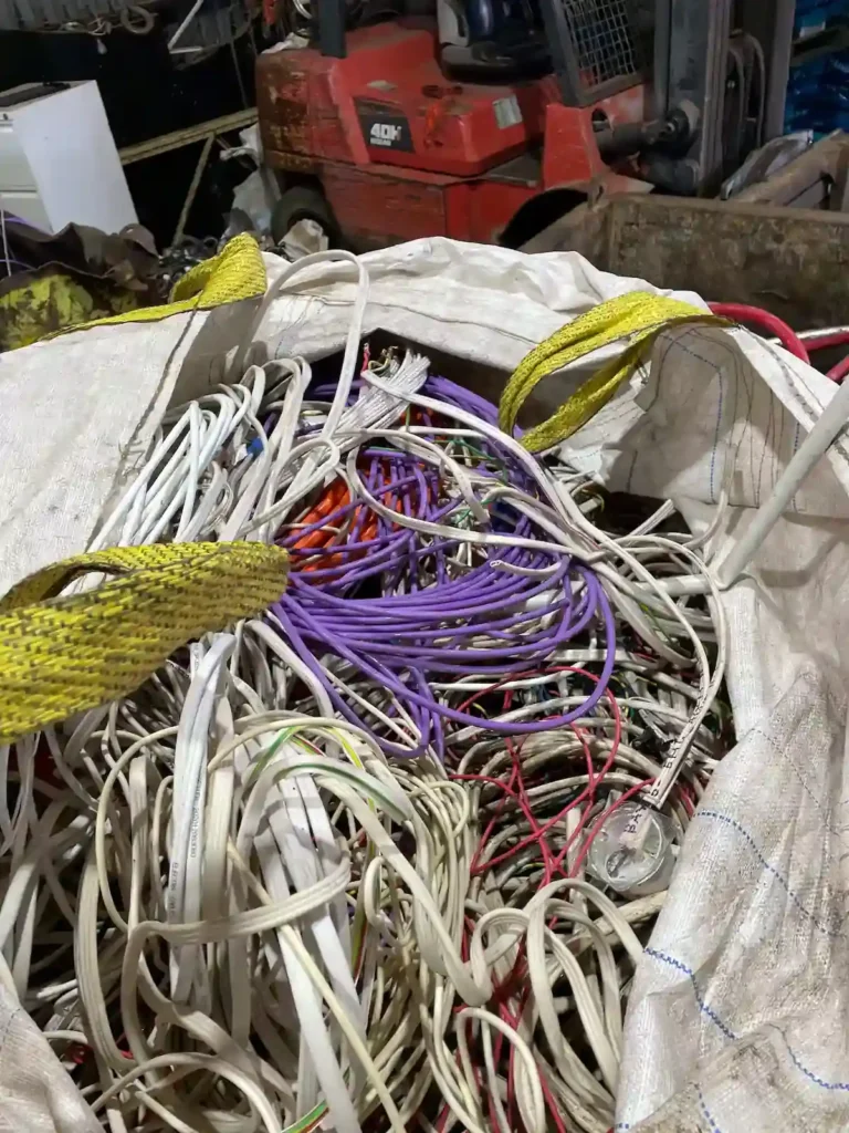 Bag full of mixed electrical cables collected for safe e waste recycling near me to reduce landfill impact.