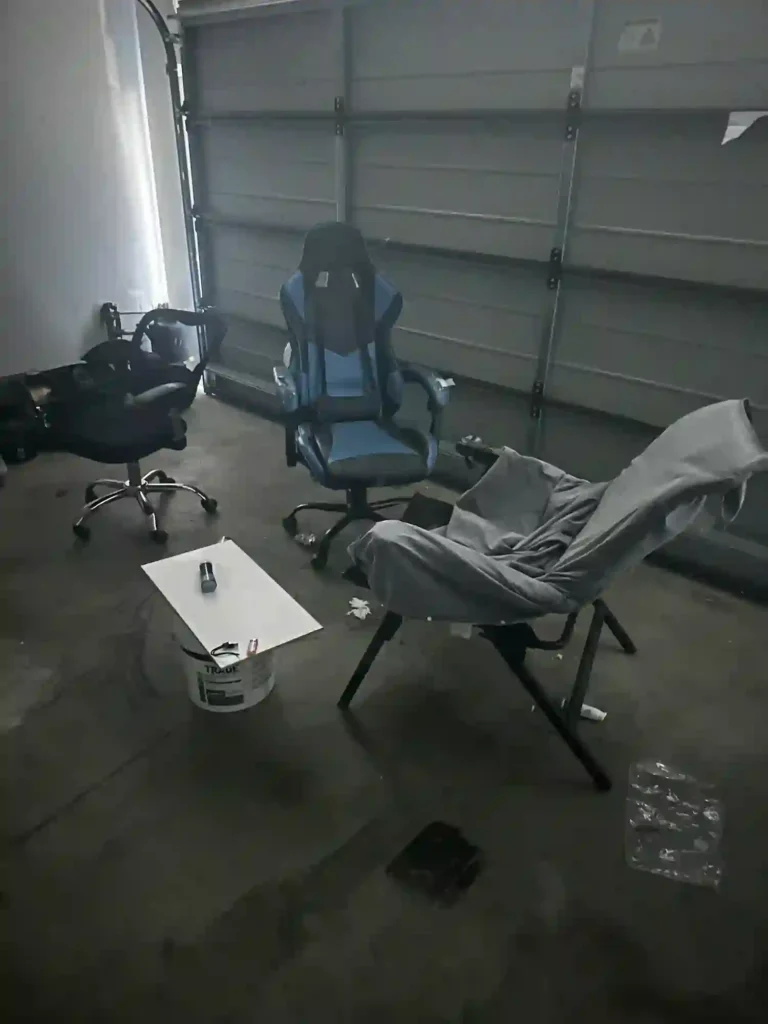 Old office chairs on wheels placed in an empty workspace, ready to be disposed of as part of an office furniture removal.