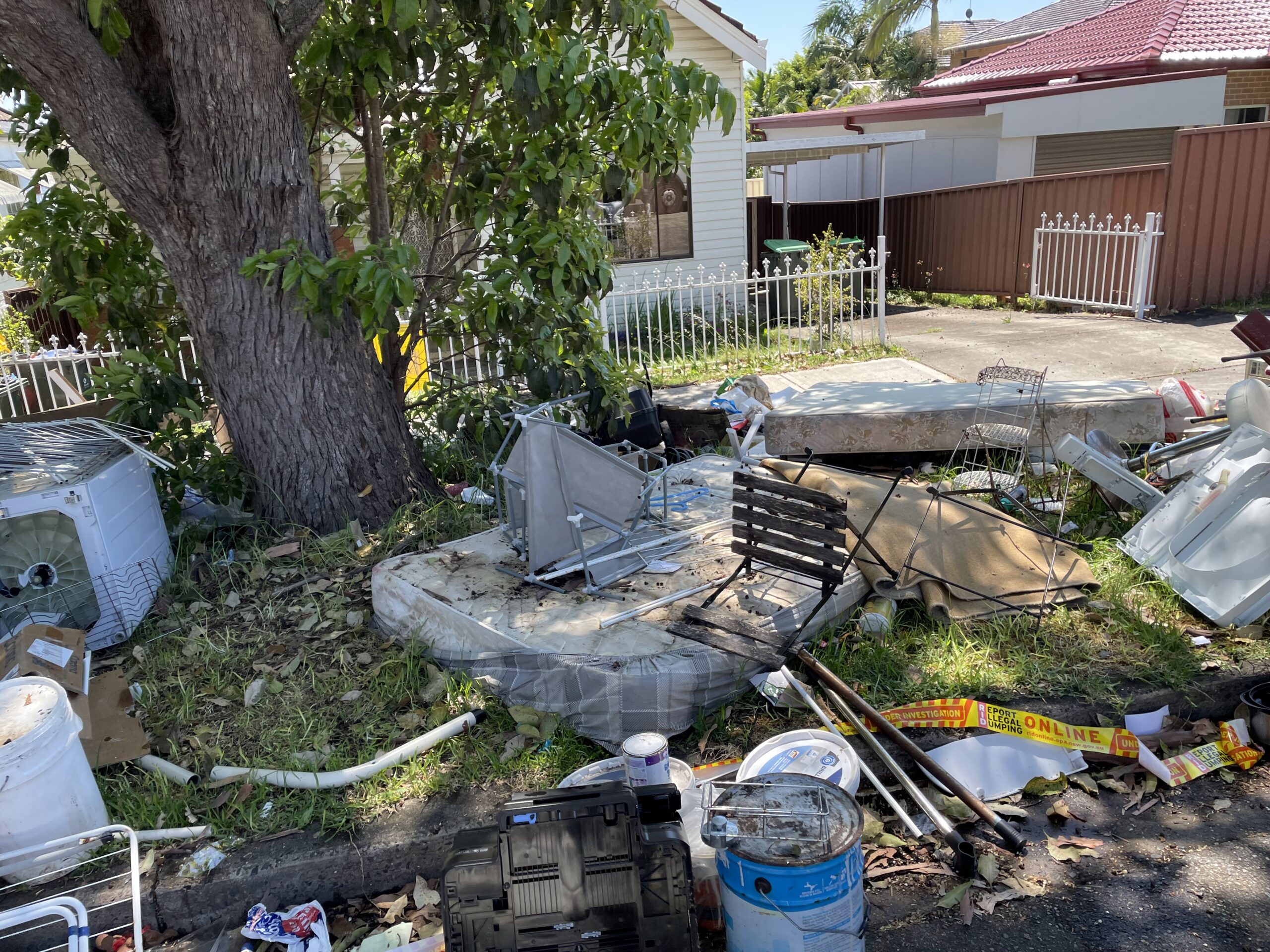 dumped household waste outside a rental property in an NSW suburb.