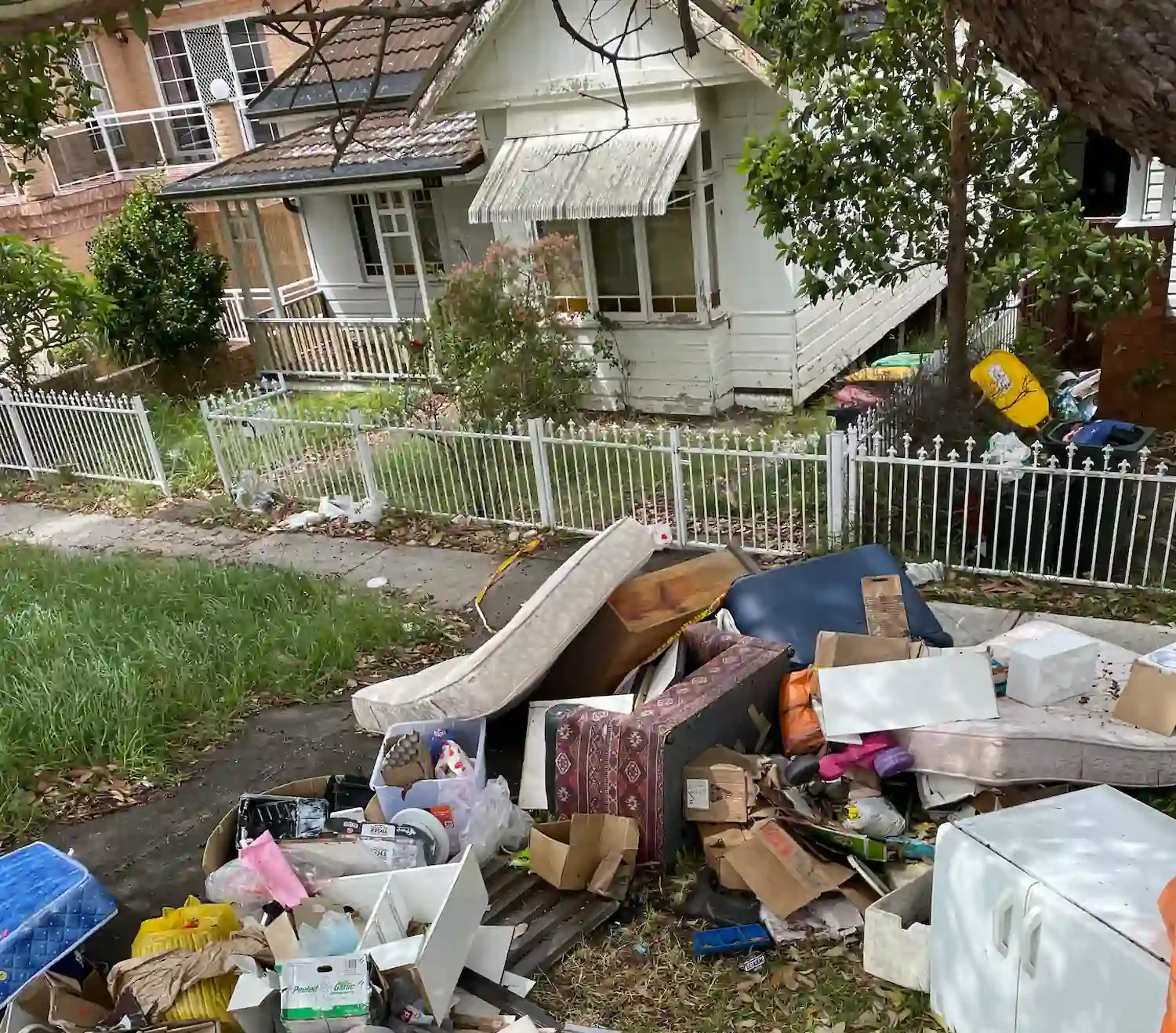 Mattresses, furniture, and household items on a lawn for Central Coast waste collection by RubbishGo.