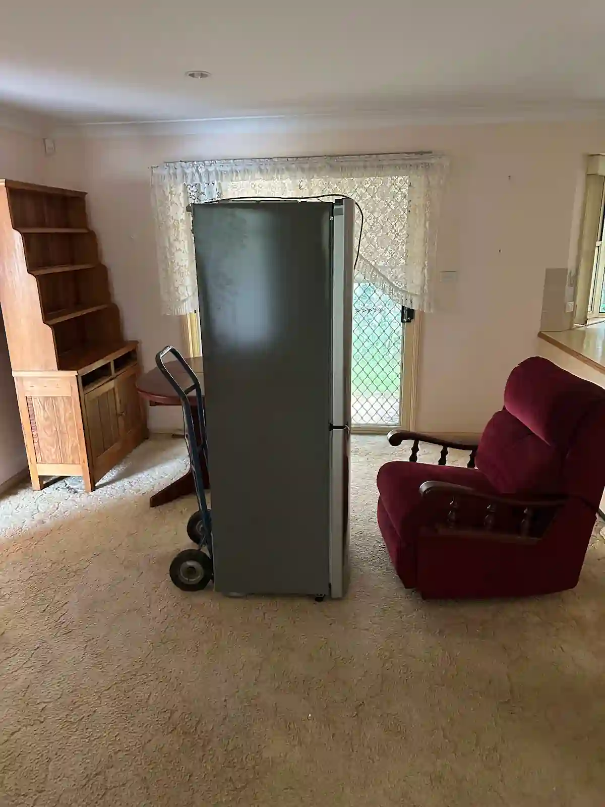 Fridge on a trolley with furniture ready for furniture removal by RubbishGo.