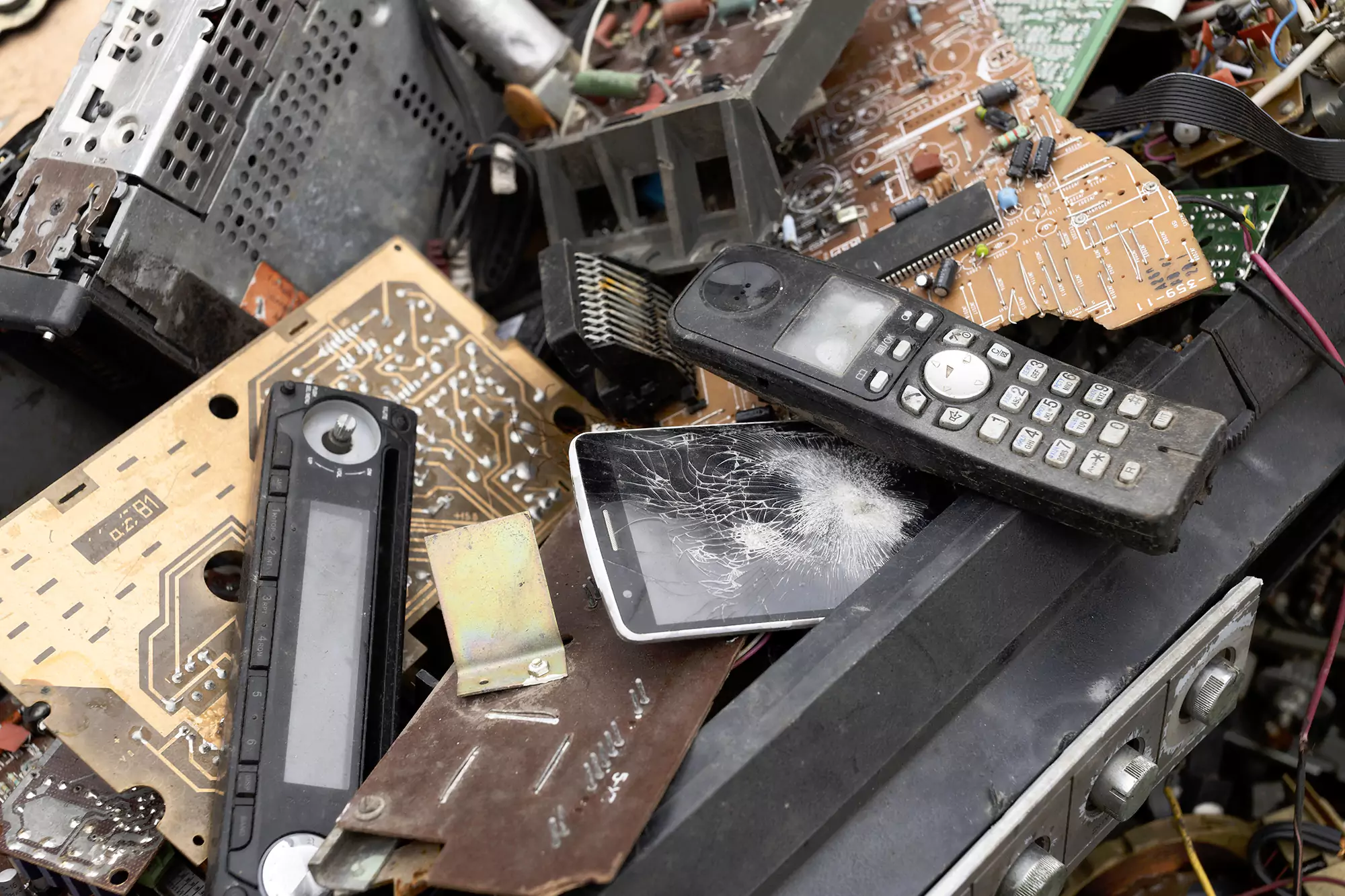 Pile of old electronic devices, circuit boards and broken electronics for e-waste recycling